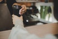 Handsome man barista serving hot coffee cup to friendly female customer Royalty Free Stock Photo