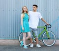 Young happy hipster couple in love meet each other and dating whis vintage bicycle. Pretty blonde caucasian woman with her