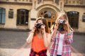 Young happy hipster teenage girls taking pictures and having fun in summer park Royalty Free Stock Photo