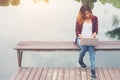 Young happy hipster woman working with her laptop sitting on pie Royalty Free Stock Photo