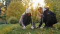 Young happy hispanic couple in love in park planting tree in gloves fertilize soil take care natural plants environment Royalty Free Stock Photo