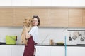 Young and happy housewife hugs her lovely pet after cleaning Royalty Free Stock Photo