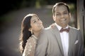 Young happy Indian couple laughing outdoors in sunshine Royalty Free Stock Photo