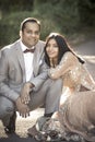 Young happy Indian couple sitting together outdoors Royalty Free Stock Photo