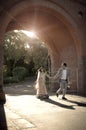 Young happy Indian couple strolling through brick archway Royalty Free Stock Photo