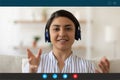 Young happy indian ethnicity businesswoman in headphones holding video call. Royalty Free Stock Photo