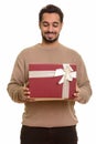 Young happy Indian man opening gift box ready for Valentine`s da Royalty Free Stock Photo