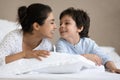 Young happy indian mother playing with small son on bed. Royalty Free Stock Photo