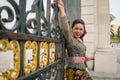 Young happy Indonesian woman from Bali having vacation in Europe - attractive and cheerful Balinese tourist girl in traditional Royalty Free Stock Photo