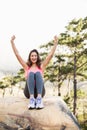 Young happy jogger sitting on rock cheering Royalty Free Stock Photo