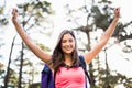 Young happy jogger sitting on rock and cheering Royalty Free Stock Photo