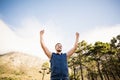 Young happy jogger standing on rock and cheering Royalty Free Stock Photo
