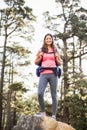Young happy jogger standing on rock looking at camera Royalty Free Stock Photo