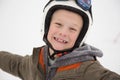 Young happy, jolly boy laughs in helmet, white background