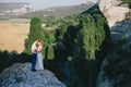 Young happy just married couple posing on the top of the mountain Royalty Free Stock Photo