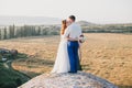 Young happy just married couple posing on the top of the mountain Royalty Free Stock Photo