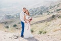 Young happy just married couple posing on the top of the mountain Royalty Free Stock Photo