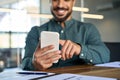 Young happy Latin business man using mobile cell phone. Close up view Royalty Free Stock Photo