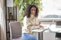 Young happy latin woman sitting at home office with laptop. Portrait Royalty Free Stock Photo