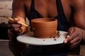 Young and happy latino american businessman creating molds a handmade clay hands pot vase in workshop. sculptor creative