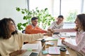 Four cheerful happy startup creative team together in office giving fist bump. Royalty Free Stock Photo