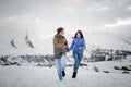 Young and happy lovers on the winter vacations spending time in mountains Royalty Free Stock Photo