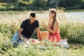 Young happy loving couple embracing and having fun together outdoors. Young couple in love on summer picnic Royalty Free Stock Photo