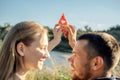 Young happy loving couple embracing and having fun together outdoors. Young couple in love on summer picnic Royalty Free Stock Photo