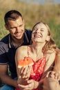 Young happy loving couple embracing and having fun together outdoors. Young couple in love on summer picnic Royalty Free Stock Photo