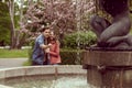 Young, happy, loving couple having date in the park near fountain. Relations, friendship and love. Royalty Free Stock Photo