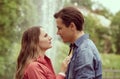 Young, happy, loving couple having date in the park near fountain. Relations, friendship and love. Royalty Free Stock Photo