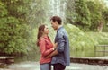 Young, happy, loving couple having date in the park near fountain. Relations, friendship and love. Royalty Free Stock Photo