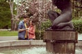 Young, happy, loving couple having date in the park near fountain. Relations, friendship and love. Royalty Free Stock Photo