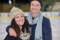 young happy loving couple hugging and skating at ice rink Royalty Free Stock Photo