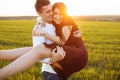 Young, happy, loving couple, outdoors, man holding a girl in his arms , and enjoying each other, advertising, and inserting text Royalty Free Stock Photo