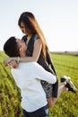 Young, happy, loving couple, outdoors, man holding a girl in his arms , and enjoying each other, advertising, and inserting text Royalty Free Stock Photo