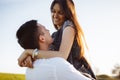 Young, happy, loving couple, outdoors, man holding a girl in his arms , and enjoying each other, advertising, and inserting text Royalty Free Stock Photo