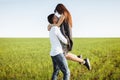 Young, happy, loving couple, outdoors, man holding a girl in his arms , and enjoying each other, advertising, and inserting text Royalty Free Stock Photo