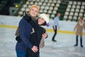 Young happy loving couple skating at ice rink Royalty Free Stock Photo