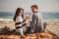 Young happy loving family with small child, enjoying time at beach sitting and hugging near ocean, happy lifestyle family concept Royalty Free Stock Photo