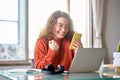 Young happy lucky woman student feeling excited winner looking at cellphone.