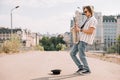 Young happy male busker playing saxophone