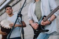 Young happy male buskers playing guitar and djembe Royalty Free Stock Photo