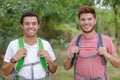 young happy male hikers looking at camera