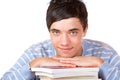 Young happy male student leaning on study books Royalty Free Stock Photo