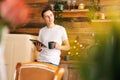 Young happy man in casual clothes holding digital tablet and drinking coffee Royalty Free Stock Photo