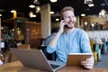 Young happy man having phone call in cafe Royalty Free Stock Photo