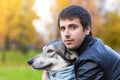 Young happy man hugging dog. pet adoption. czechoslovak with male owner Royalty Free Stock Photo