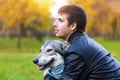 Happy man hugging dog. pet adoption.  czechoslovak with male owner. boy walking, playing, training Saarlos wolfdog in the park Royalty Free Stock Photo