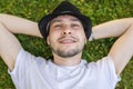 Young happy man is lying and relaxing in grass in park Royalty Free Stock Photo